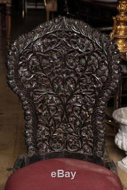 A Tall Black Ornately Carved End Chair from India