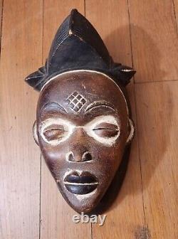 Hand carved, stained and painted wood Punu mask from Gabon, Africa
