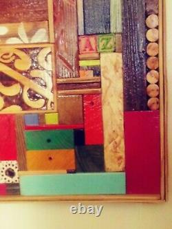 Hanging wood art piece made from different sized and colored block of wood