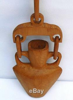Large carved whimsy with a bold look two handled vase withtwo links from a yoke